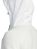 A person wearing the Hedge Men's Performance Hoodie by Nobis, featuring a textured knit design and made from luxurious merino wool, seen from the side.