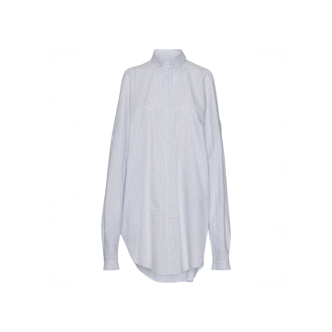 The Henrik Vibskov New Bumble Shirtdress, a long-sleeved light blue and white checkered button-up with a collar, is inspired by the White Blue Grid design and shown against a plain white background.