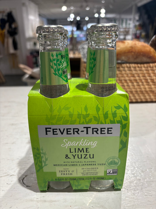 Two bottles of Westerlind Sparkling Lime & Yuzu beverage on a store shelf, in vibrant green packaging.