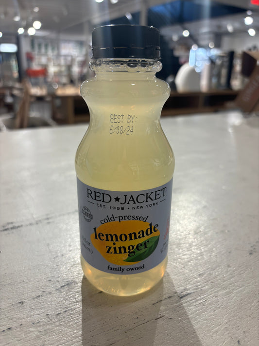A bottle of Westerlind Cold Pressed Lemonade Zinger on a store shelf, displaying a "best by" date of 6/08/24.