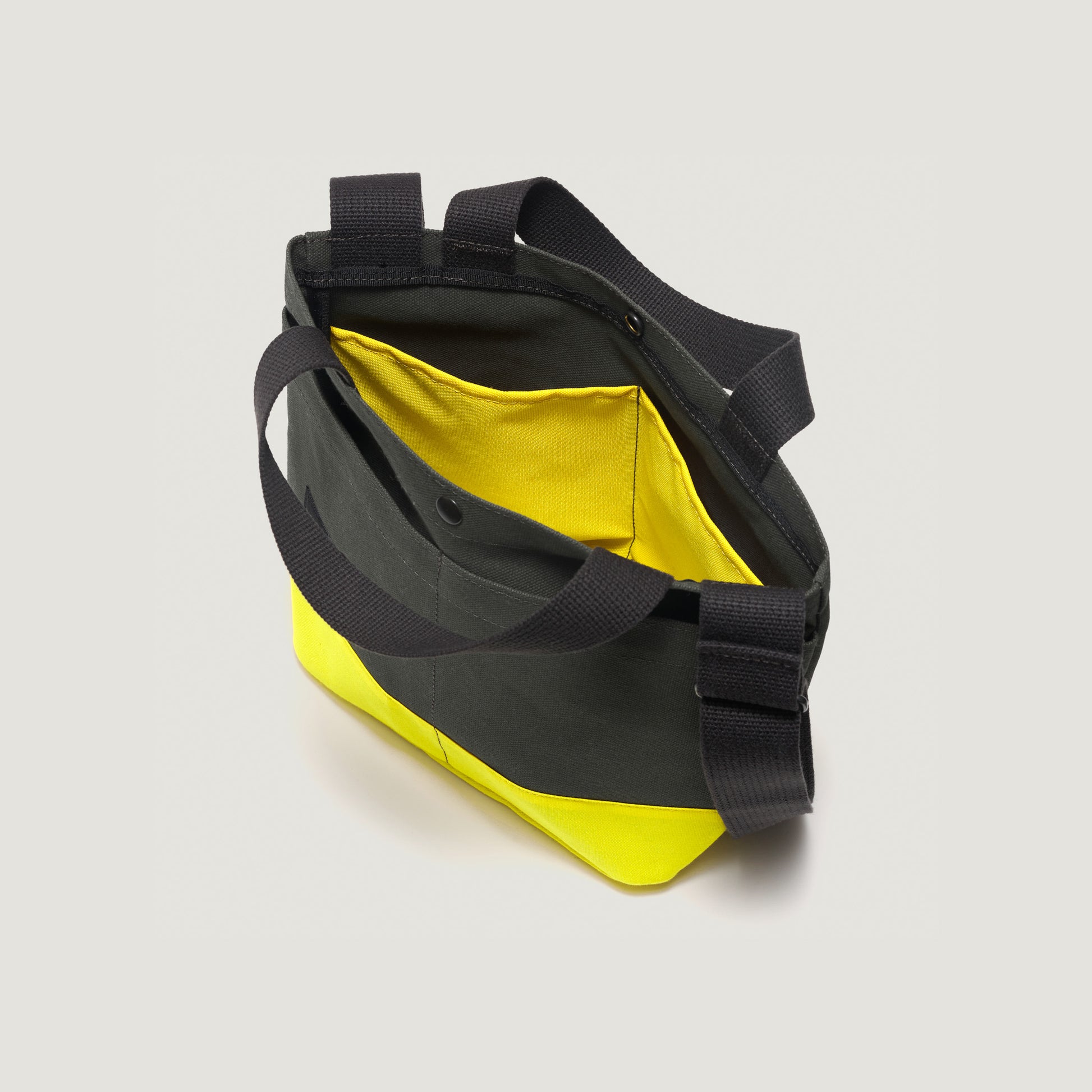 Introducing the New York Tote Small by Bags in Progress, Special Edition in Forest Green/Yellow, featuring two black handles, a shoulder strap, and a visible yellow interior pocket.