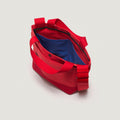The New York Tote Small, Special Edition: Red/Red by Bags in Progress features wide handles, a blue interior, and a versatile shoulder strap. Shown from above.