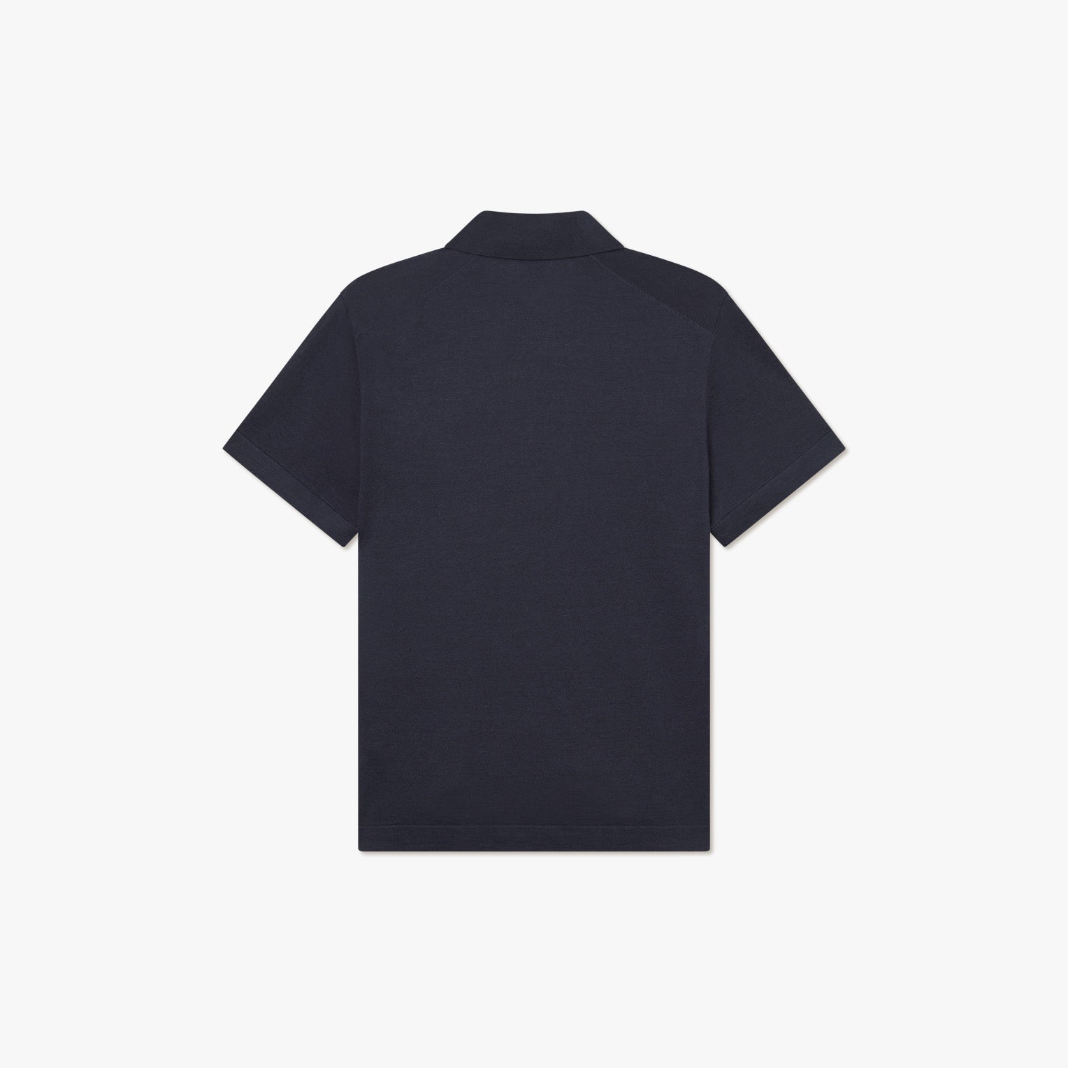 Back view of the Les Deux Knit Polo, a plain short-sleeve shirt in dark navy linen blend, laid flat on a white background.