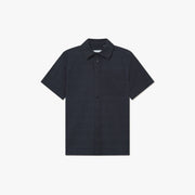 The Charlie SS Shirt by Les Deux is a dark navy short-sleeve button-up with vintage styling, a collar, and single chest pocket, shown against a plain white background.