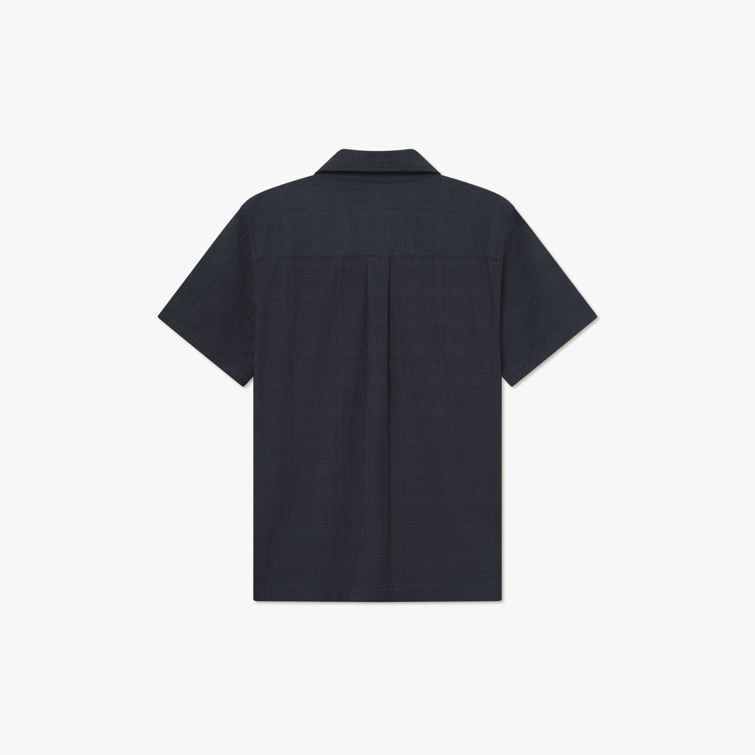 Back view of the Les Deux Charlie SS Shirt, a short-sleeve dark navy collared shirt with vintage styling, laid flat on a white background.