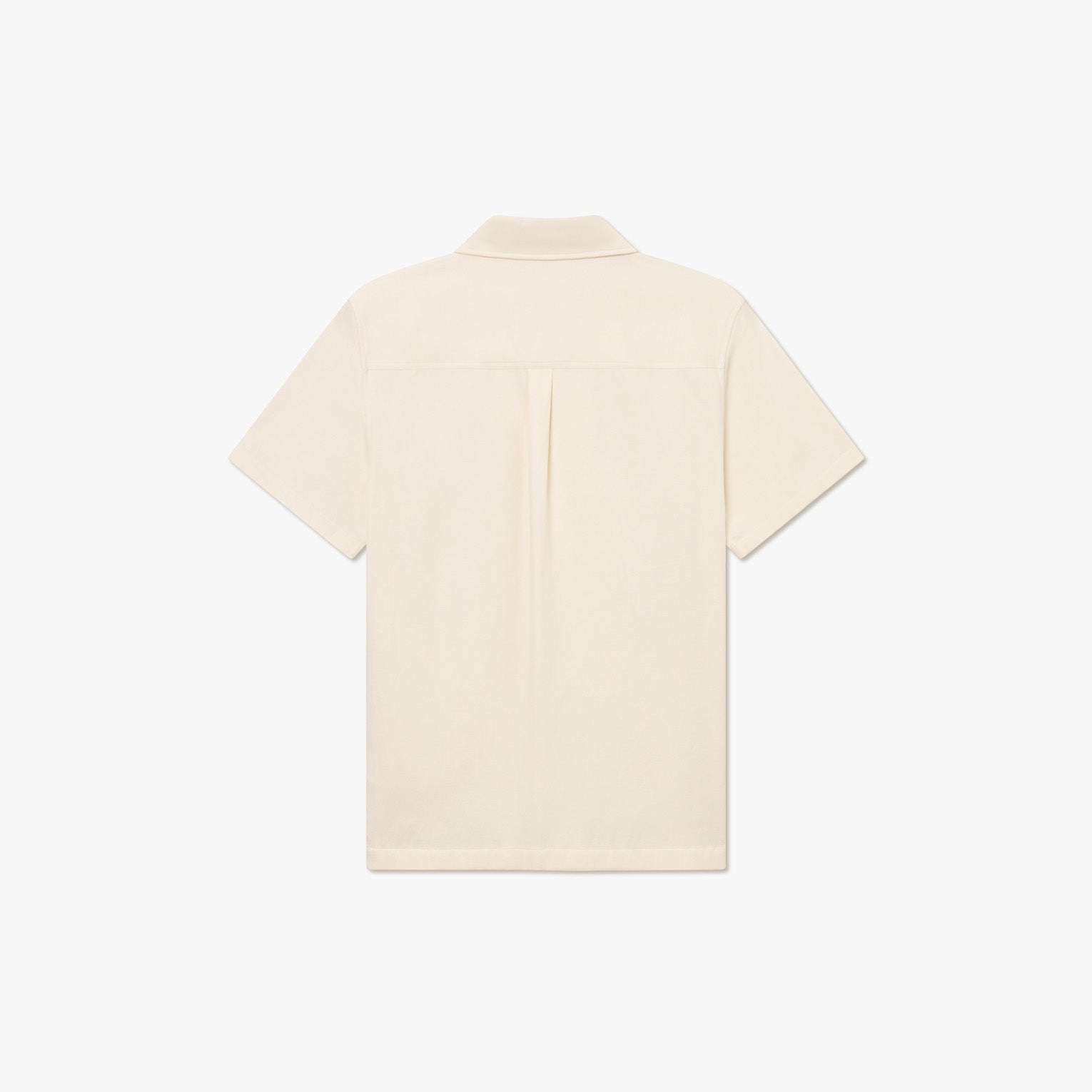 The Kingsley AOE SS Shirt by Les Deux is a cream-colored, short-sleeve organic cotton shirt shown from the back, featuring a straight hem and single center pleat below the yoke.
