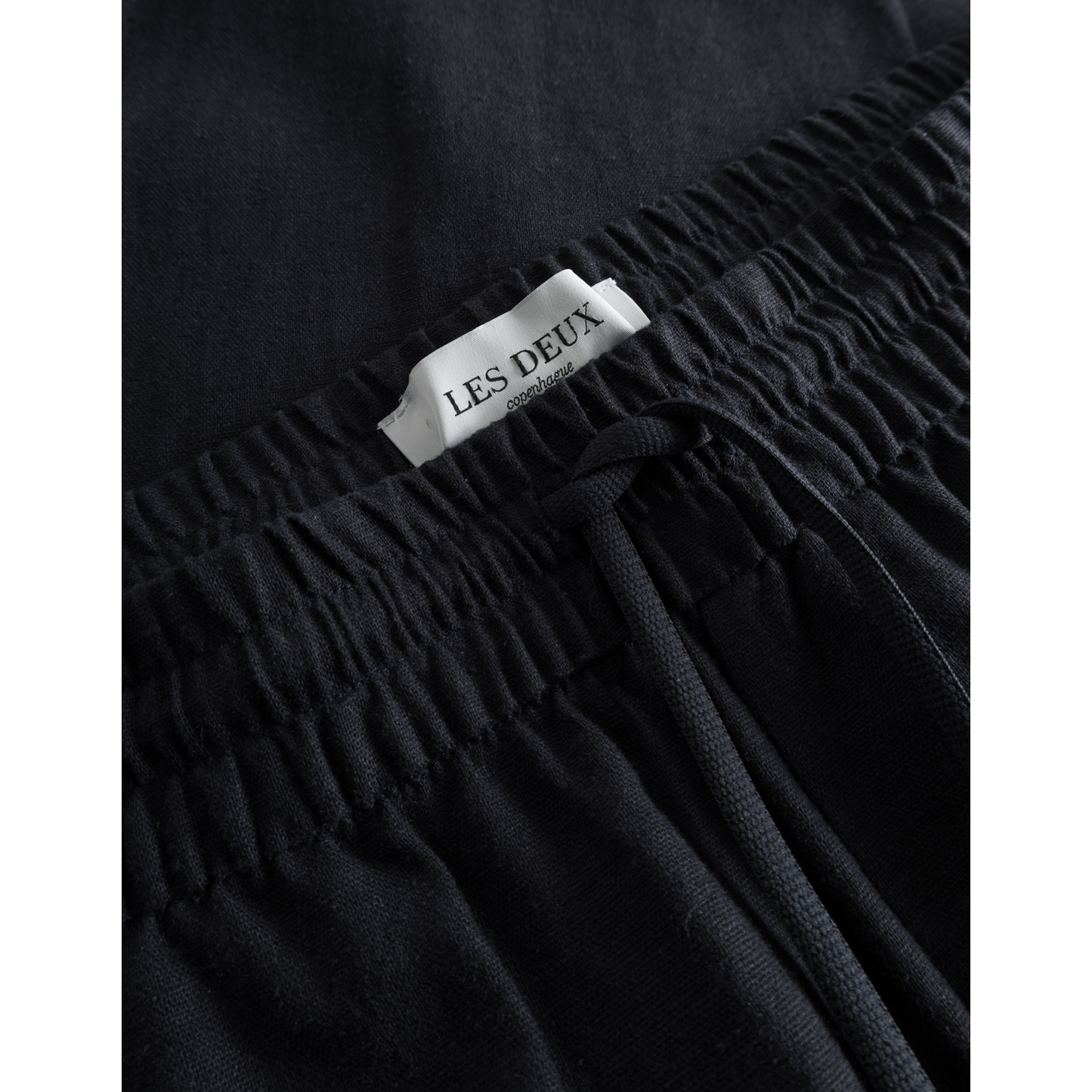 Close-up of a dark navy Patrick Linen Pants by Les Deux, featuring detailed stitching and breathable material.