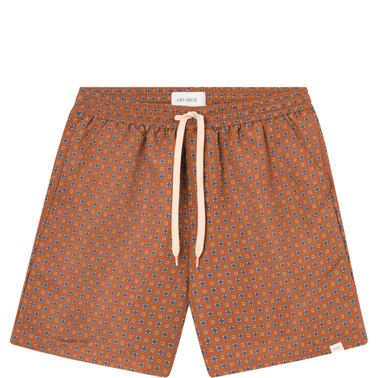 Patterned Stan AOP Swim Shorts 2.0 in Terrocotta/Pineapple with a white drawstring waist on a white background by Les Deux.