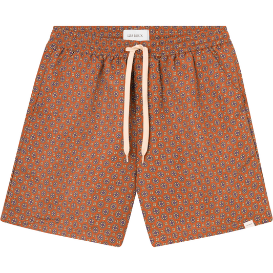 Patterned Stan AOP Swim Shorts 2.0 in Terrocotta/Pineapple with a white drawstring waist on a white background by Les Deux.