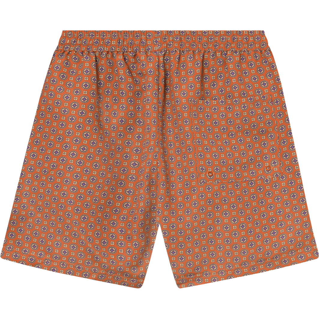 Patterned Stan AOP Swim Shorts 2.0 in Terrocotta/Pineapple with a paisley design, featuring a drawstring waist and a flat-laid display by Les Deux.