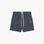 The Stan Ornament AOP Swim Shorts 2.0 by Les Deux feature a navy blue base with red and light blue geometric patterns, an elastic waistband, and a white drawstring.