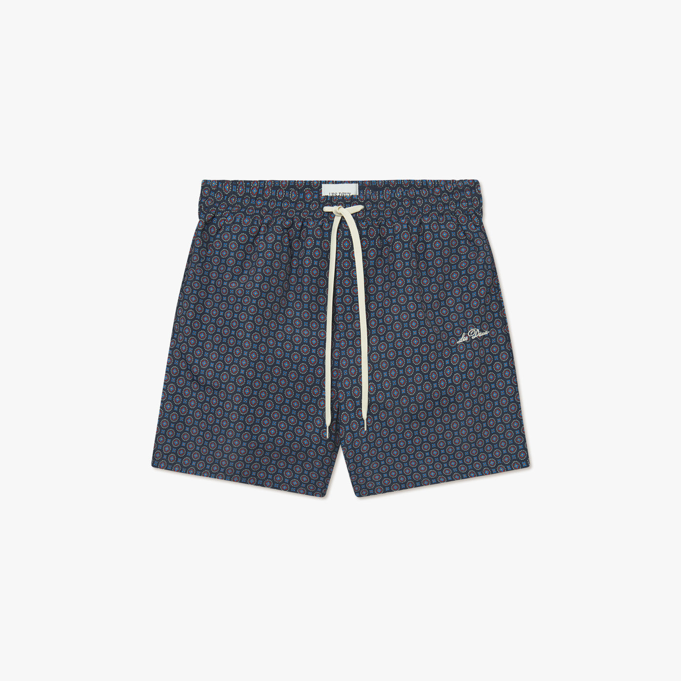 The Stan Ornament AOP Swim Shorts 2.0 by Les Deux feature a navy blue base with red and light blue geometric patterns, an elastic waistband, and a white drawstring.