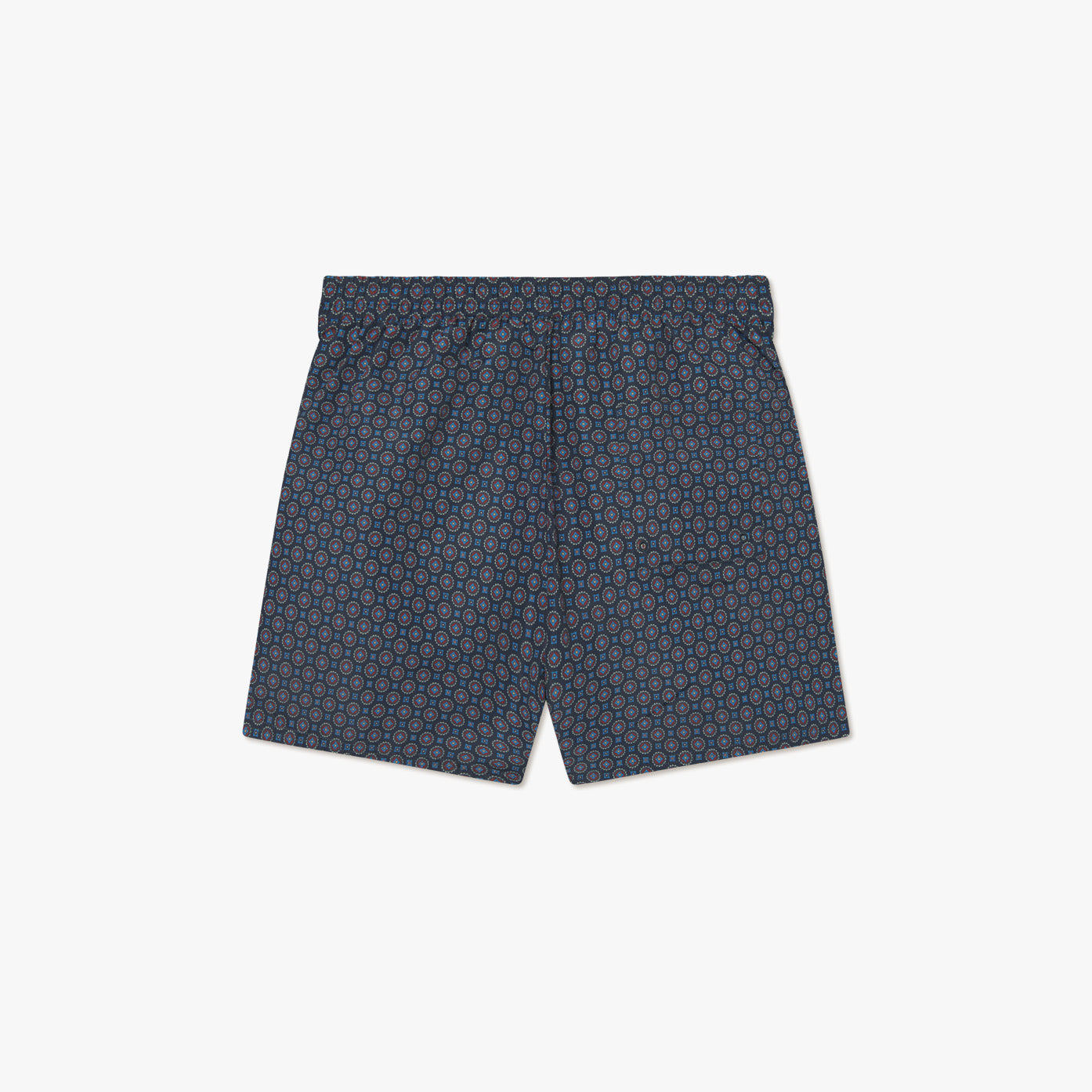 Les Deux Stan Ornament AOP Swim Shorts 2.0 in navy blue feature an all-over geometric circular pattern, elastic waistband, and no visible branding, shown against a white background.