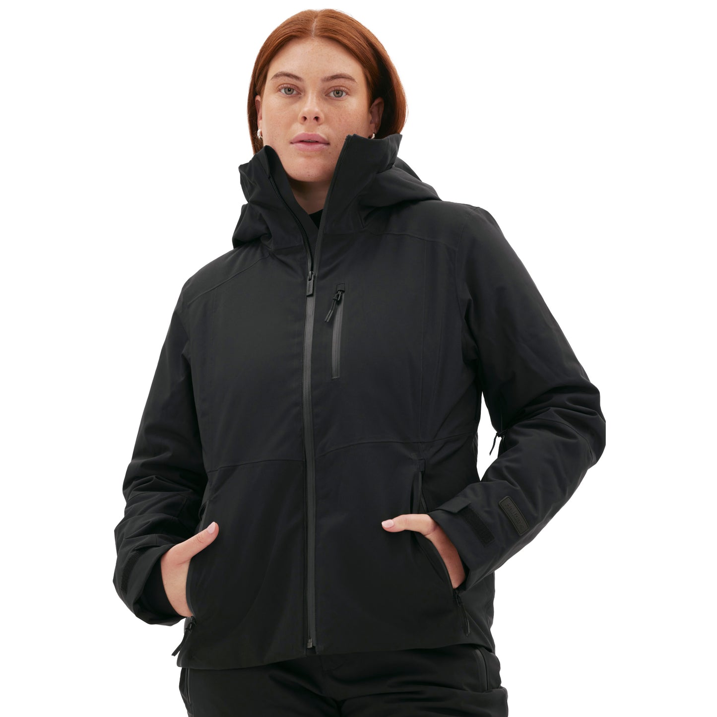A woman wearing a black Halfdays Lawrence Jacket stands with her hands in her pockets against a plain background.