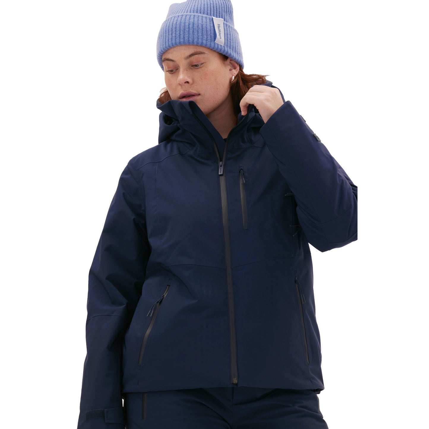A person is wearing a stylish Lawrence Jacket by Halfdays, paired with a light blue beanie against a crisp white background.