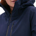 Close-up of a woman wearing the Halfdays Lawrence Jacket, a dark blue insulated ski jacket with a zip, ideal for hitting the slopes.