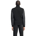 A person in a black Nobis Layton Men's Tactical Hybrid Sweater and jeans is shown from behind against a white background.