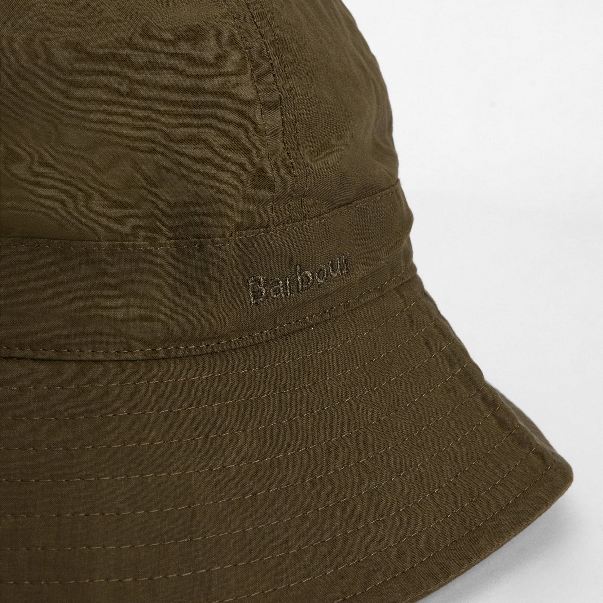 Close-up of the Barbour Transport 6 Panel Bucket Hat in olive green, featuring visible stitching and "Barbour" embroidered on the side.