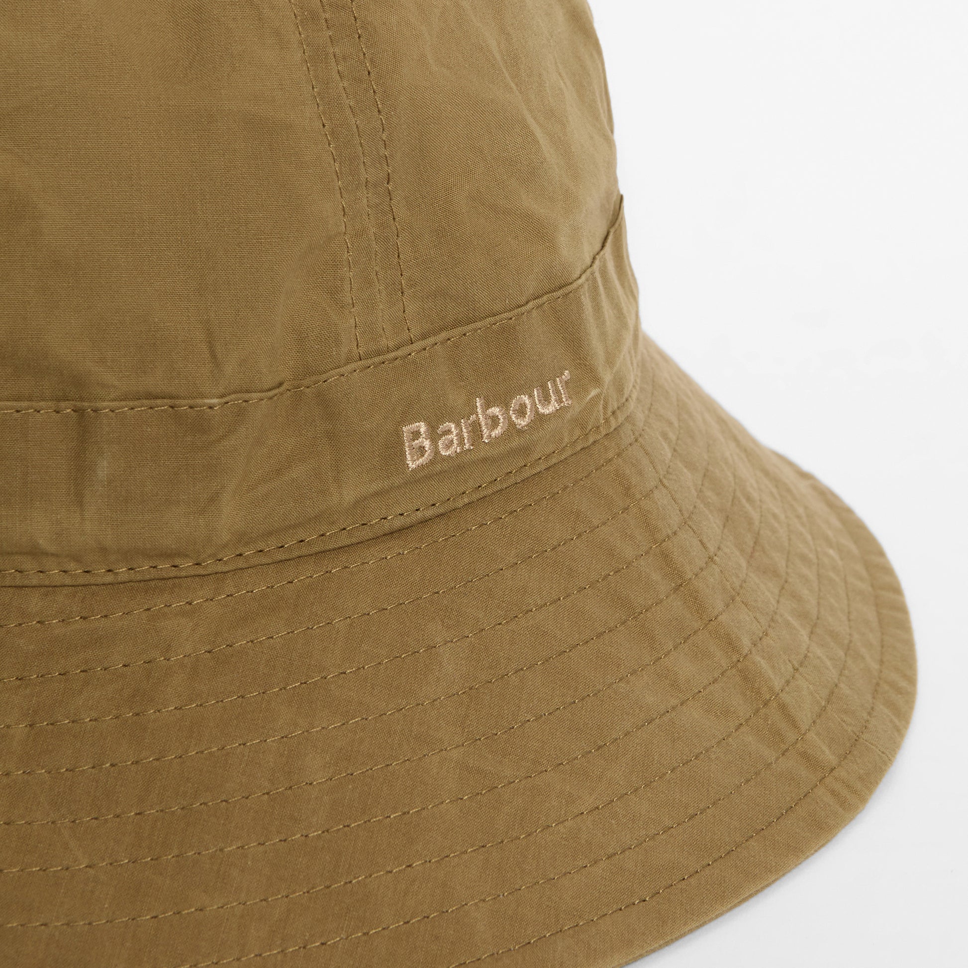 A close-up of the Barbour Transport 6 Panel Bucket Hat in khaki, featuring "Barbour" embroidered on the band.