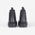 Rear view of Barbour's Nimbus Chelsea Welly in black, showcasing sleek pull tabs and a subtle mudguard, set against a plain white background.