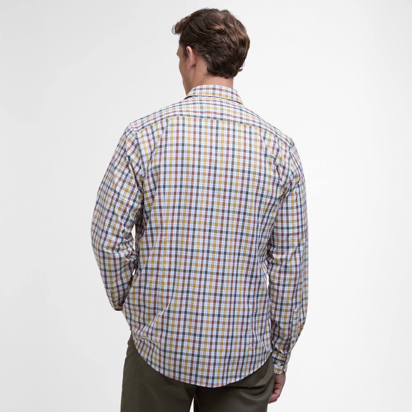 A person displays the back of a Barbour Hallhill Performance Shirt, featuring a check design under its long-sleeve plaid pattern, against a plain background.