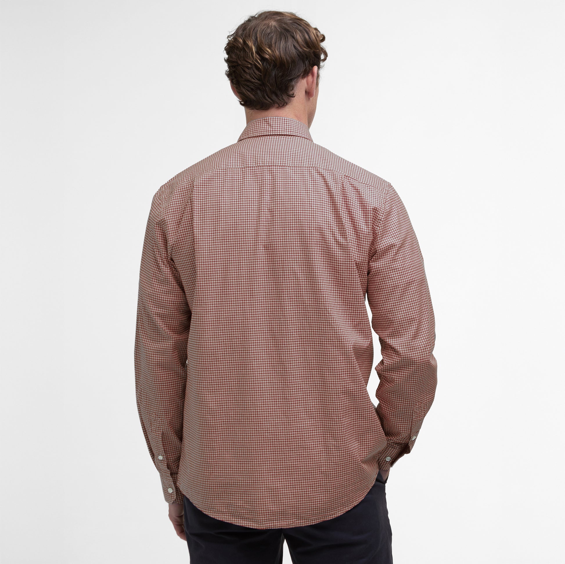 A person is seen from the back against a plain white background, wearing a brown checkered Finwell Gingham Tailored Fit Shirt by Barbour, made from 100% cotton.