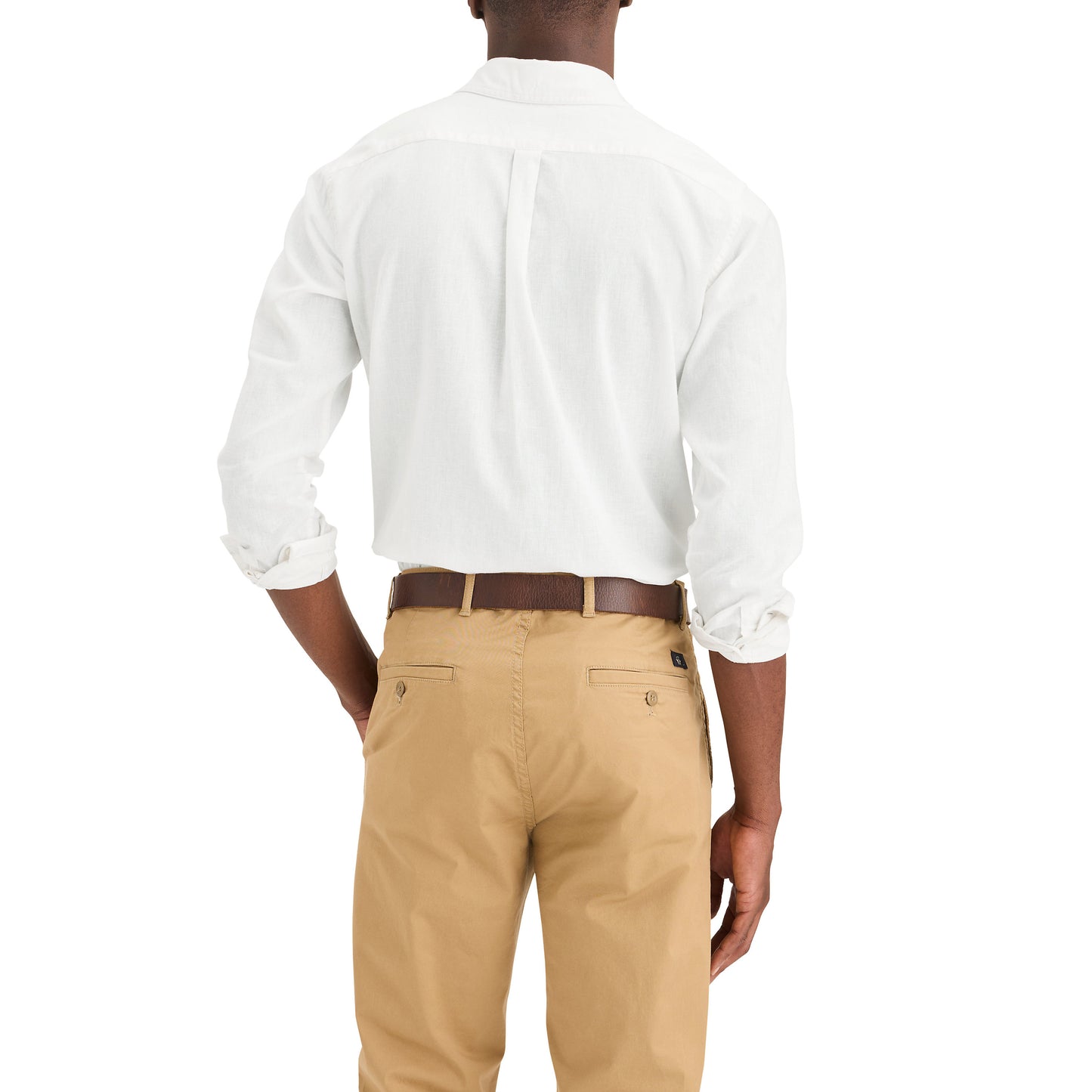 A person is seen from behind wearing Dockers' Men's Original Shirt, LS—a white button-up—paired with beige pants and a brown belt, offering a comfortable fit with a clean-cut look.