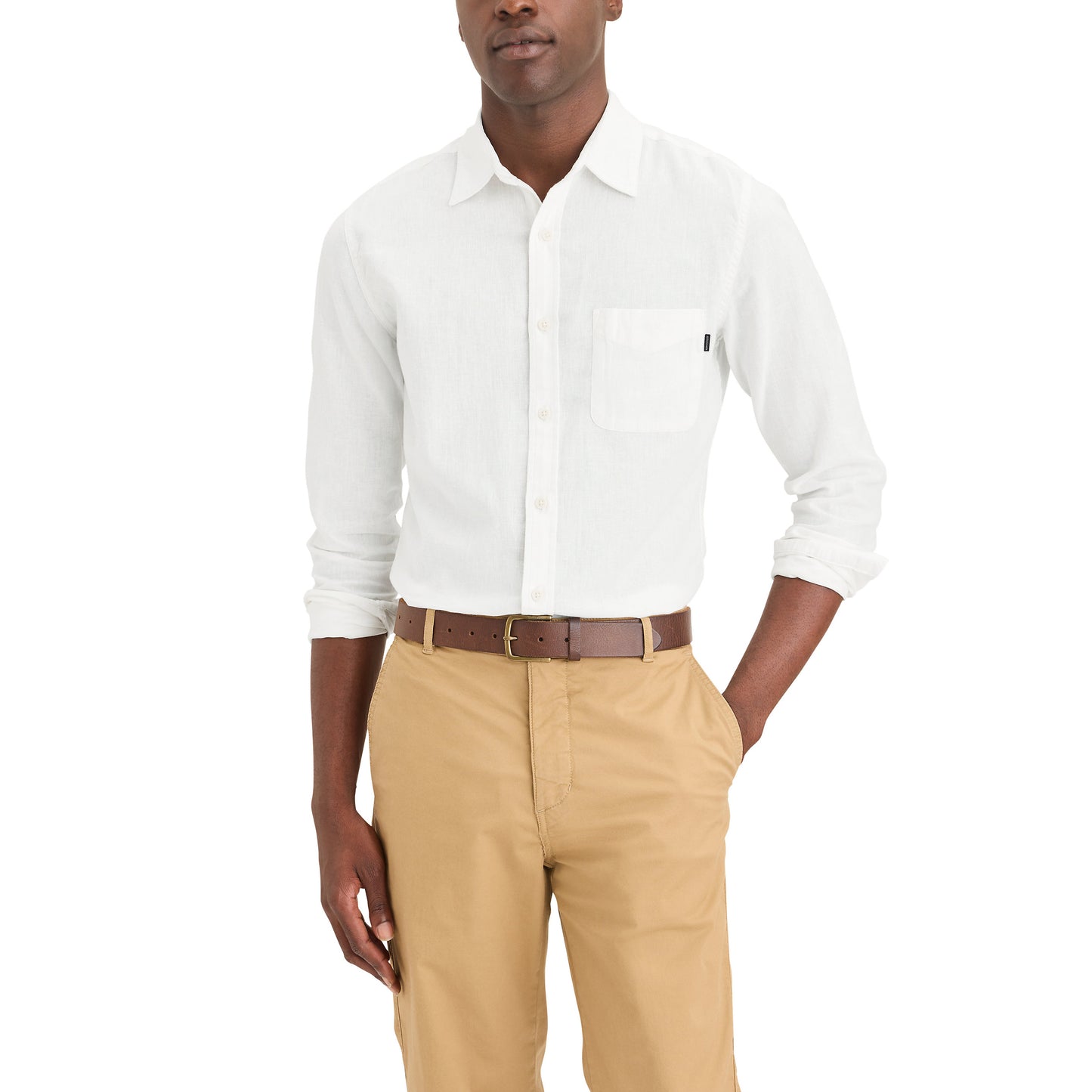 A person in a Dockers Men's Original Shirt, LS, and khaki pants strikes a casual pose with hands in pockets against a white background.