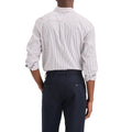 A man, seen from behind, wears a Dockers Men's Signature Shirt, LS with rolled-up sleeves and dark pants, standing against a plain white background.