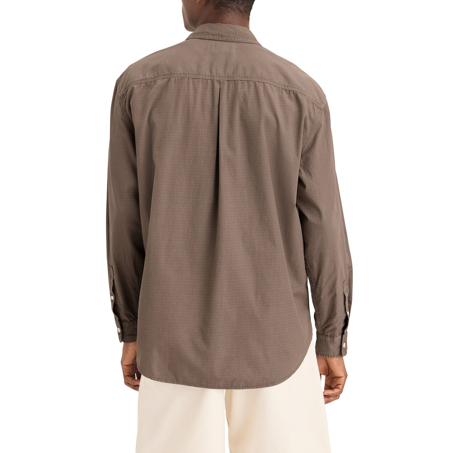 A person is seen from the rear wearing Dockers' Genderless 86 1-Pocket Shirt, LS, in brown with beige pants. The relaxed-fit long-sleeve cotton ripstop shirt includes buttoned cuffs for added elegance.