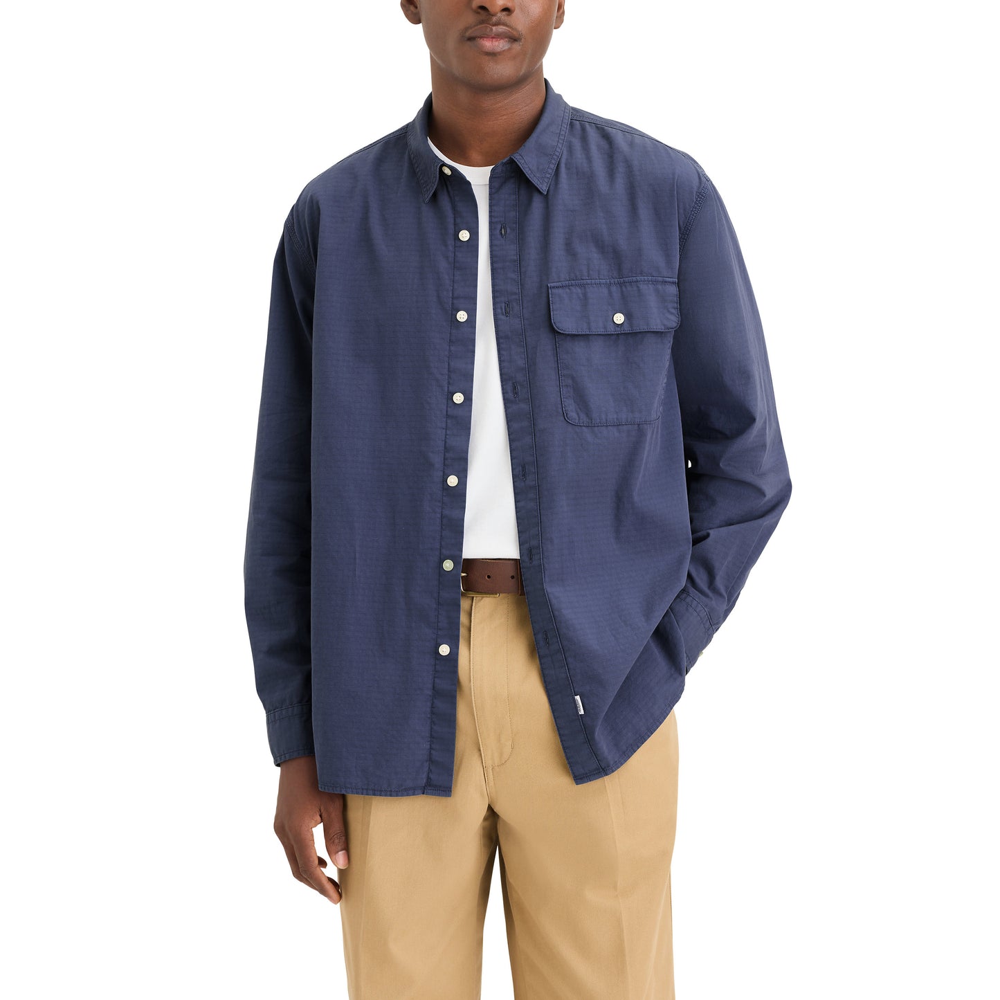 A person in a relaxed fit sports Dockers' Genderless 86 1-Pocket Shirt, LS in blue cotton ripstop over a white t-shirt, paired with beige pants.