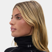 Woman wearing a black high-neck gaiter with a brand logo "H" on a white background