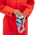 A person in a Murphy Ski Suit by Halfdays is carefully cleaning ski goggles with a cloth, capturing the timeless charm of vintage racing-style suits.