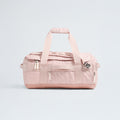 The North Face Base Camp Voyager Duffel - 42L is a light pink bag with two handles, a shoulder strap, and multiple zippered compartments—its lightweight design makes it the ideal travel companion, shown against a plain light background.