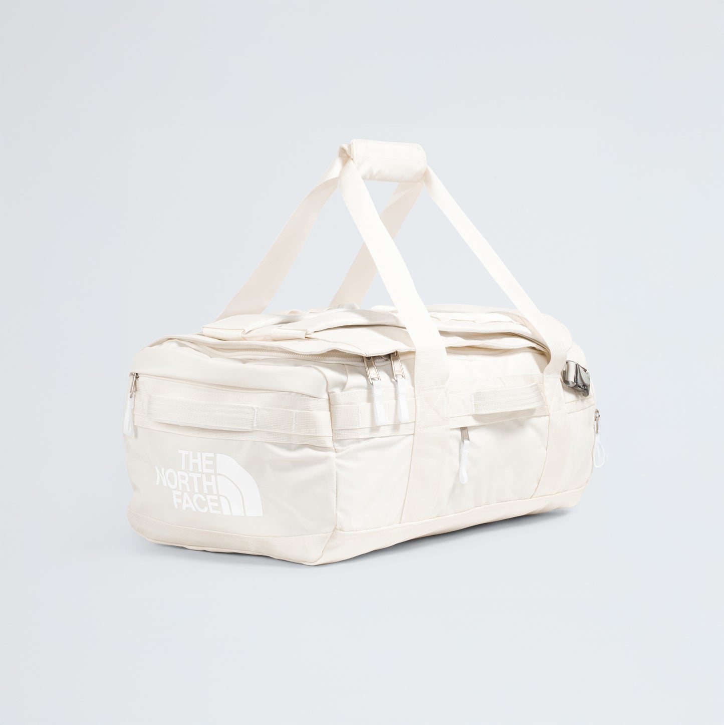 A spacious off-white Base Camp Voyager Duffel - 42L by The North Face with handles and zip pockets, lightweight for travel, shown on a plain light background—an ideal companion for your journeys.