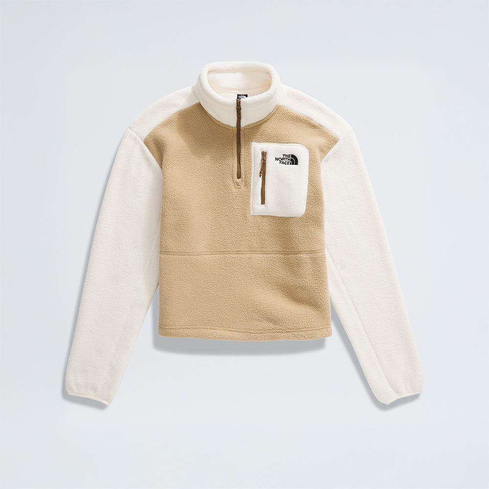 The North Face W Yumiori 1/4 Zip is a sustainably-designed, tan and white pullover made from recycled fleece. It features a quarter zip, stand-up collar, chest pocket, and The North Face logo on the left side.