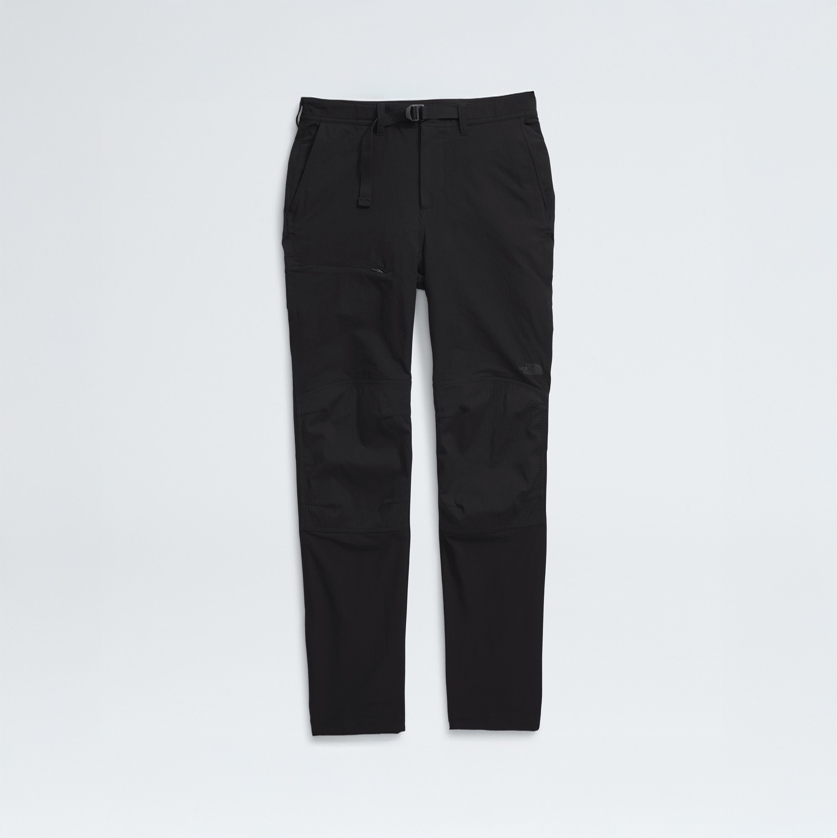 The North Face M Basin Pro Pant: black, slim-fit hiking pants featuring four-way stretch, zippered pockets, and reinforced knees, shown on a white background.