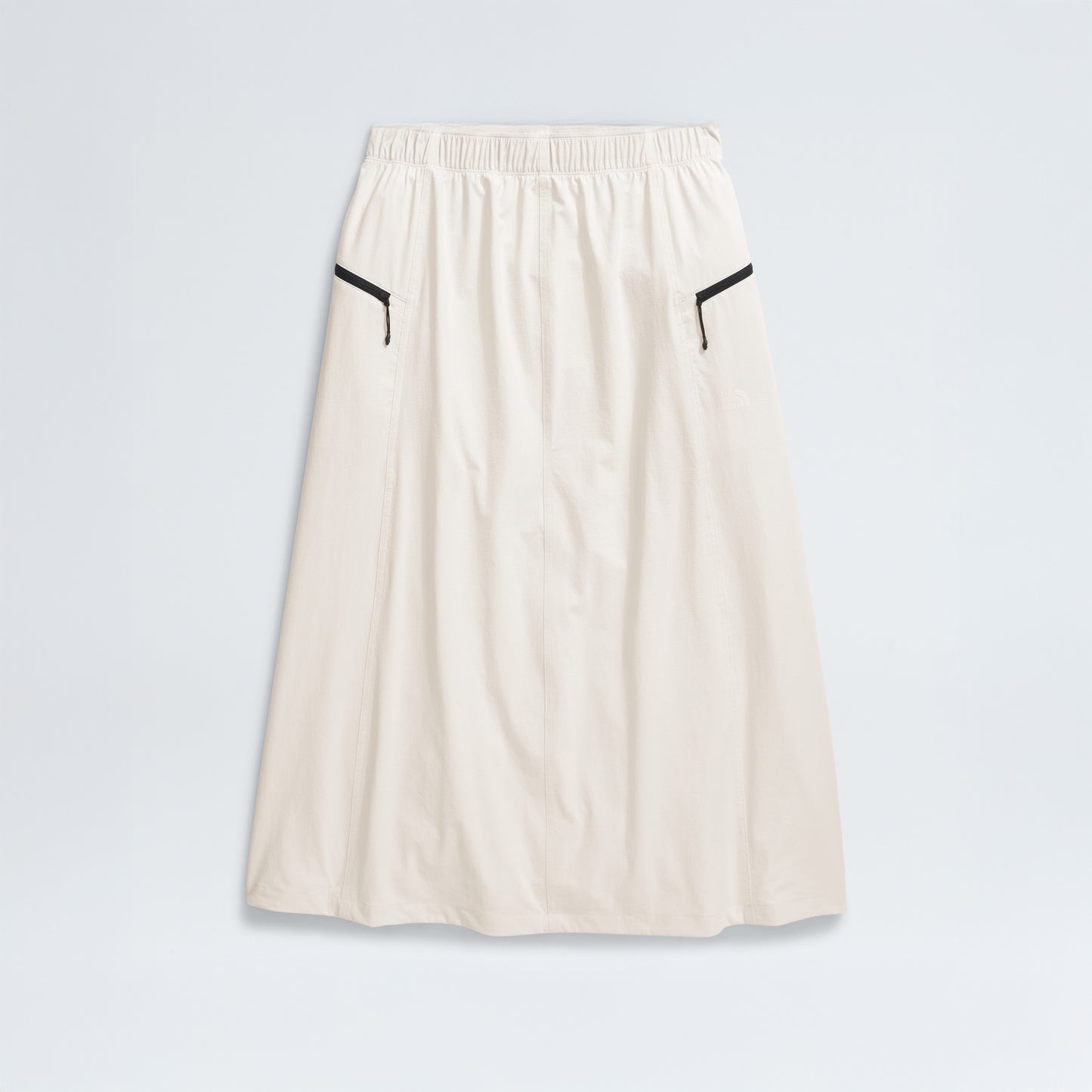 The North Face's W North Dome Wind Skirt is a long white skirt featuring an elastic waistband and black trim on two side pockets, shown against a plain background.