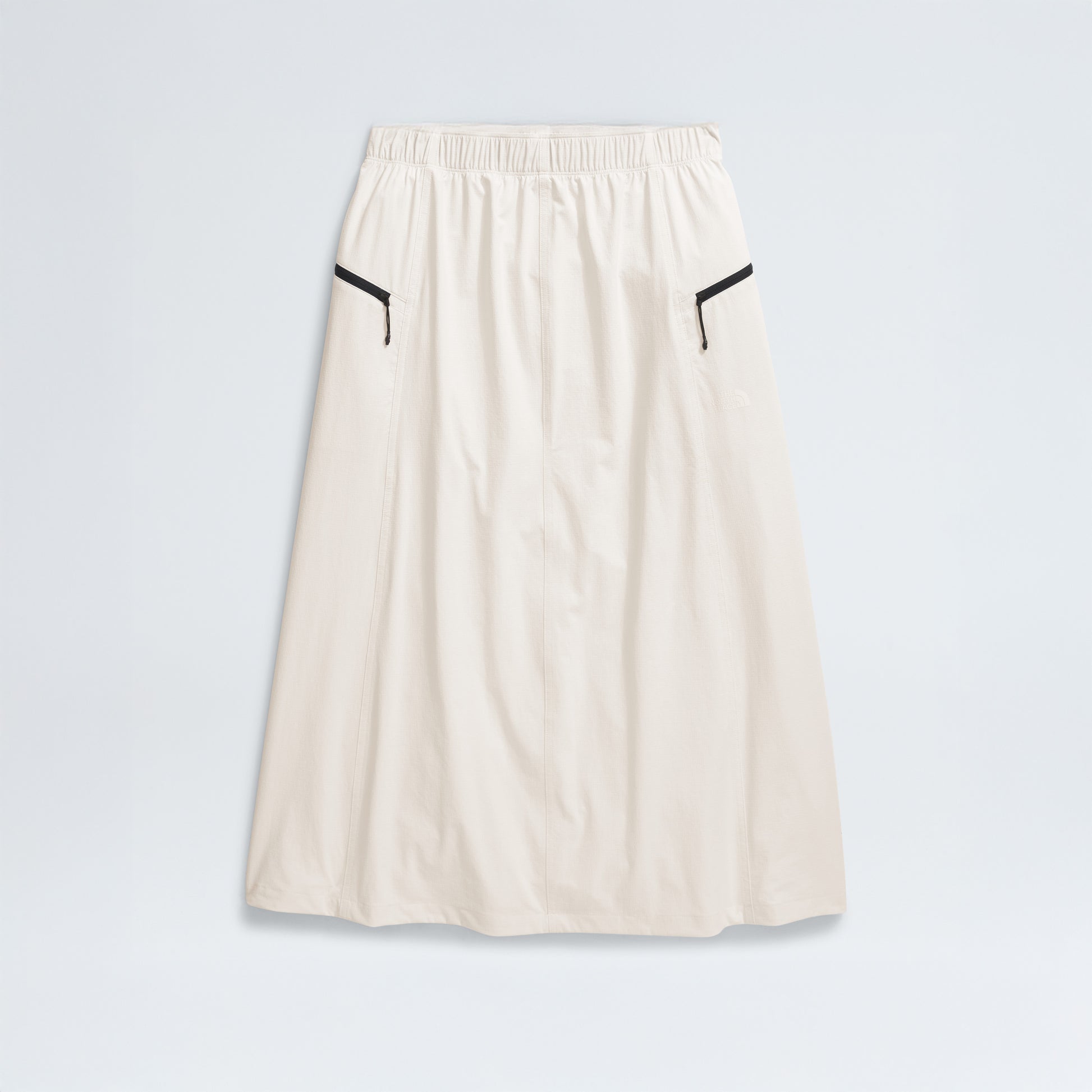 The North Face's W North Dome Wind Skirt is a long white skirt featuring an elastic waistband and black trim on two side pockets, shown against a plain background.