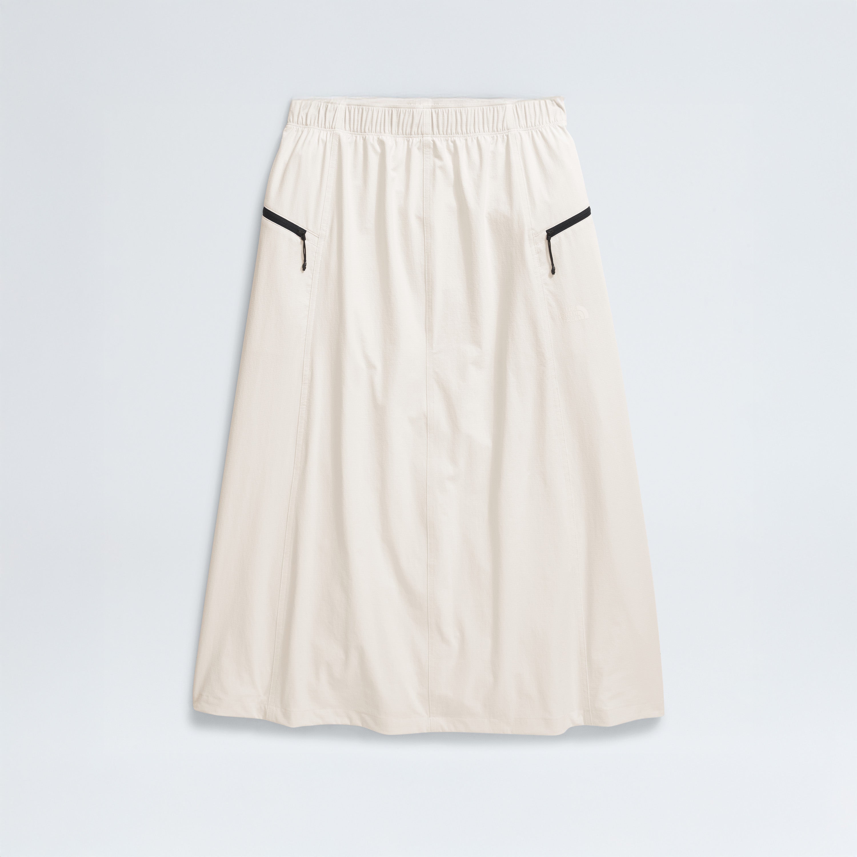 The North Face's W North Dome Wind Skirt is a long white skirt featuring an elastic waistband and black trim on two side pockets, shown against a plain background.