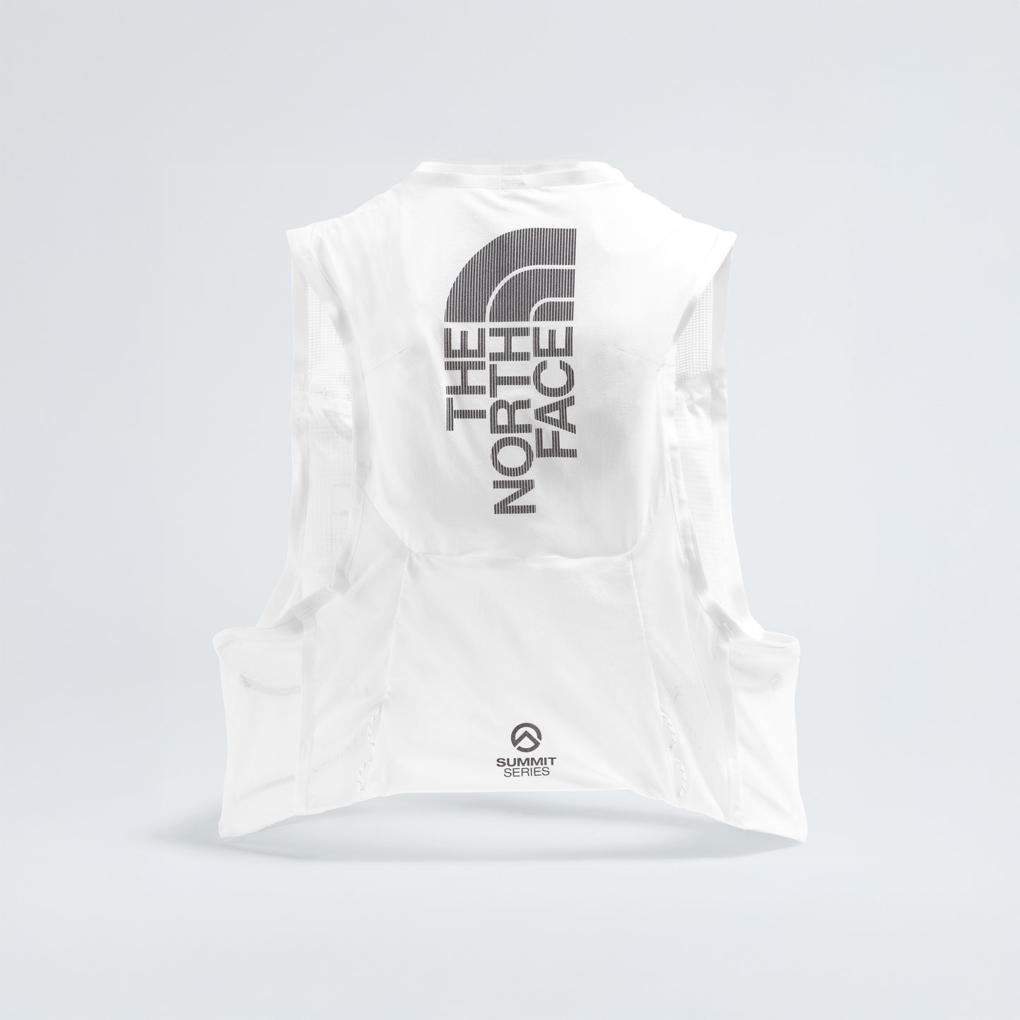 The U Summit Run Vest 5 by The North Face is a white sleeveless athletic vest for race day, featuring a large logo on the back and "Summit Series Run Vest" text near the bottom.