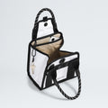 The North Face Base Camp Mini Tote, made from recycled fabric, features a stylish black and white exterior with rope handles. Inside, it has a beige lining and organized compartments, including conveniently clipped keys.