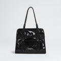 The North Face Base Camp Tote Bag is a black, glossy tote with rope handles, a front pocket, and the logo on the lower front. It features durable construction and internal organization for your essentials.
