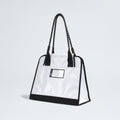 The North Face Base Camp Tote Bag is durable and white, featuring black handles, black trim, a small transparent front pocket for organization—shown against a plain light background.