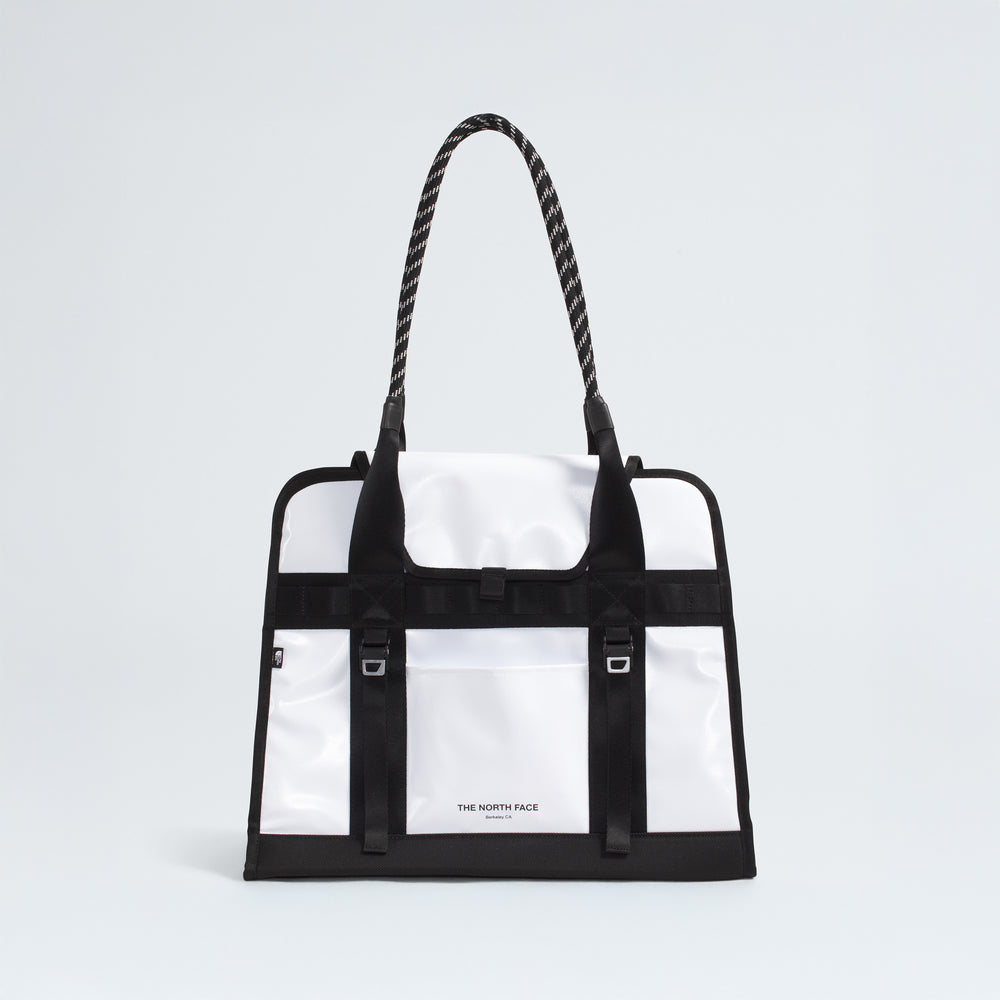 The North Face Base Camp Tote Bag features a durable white and black design, rope handles, black strap details, internal organization, and the brand logo on the front.