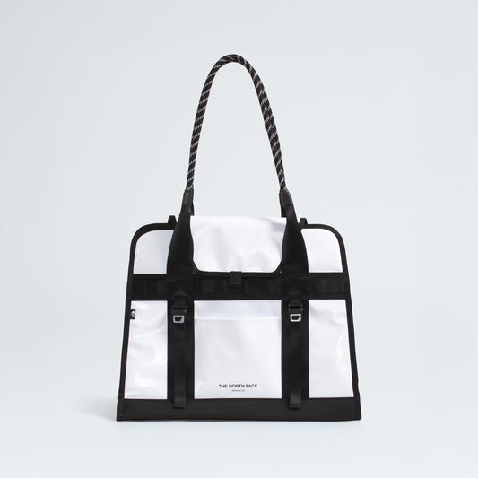 The North Face Base Camp Tote Bag features a durable white and black design, rope handles, black strap details, internal organization, and the brand logo on the front.