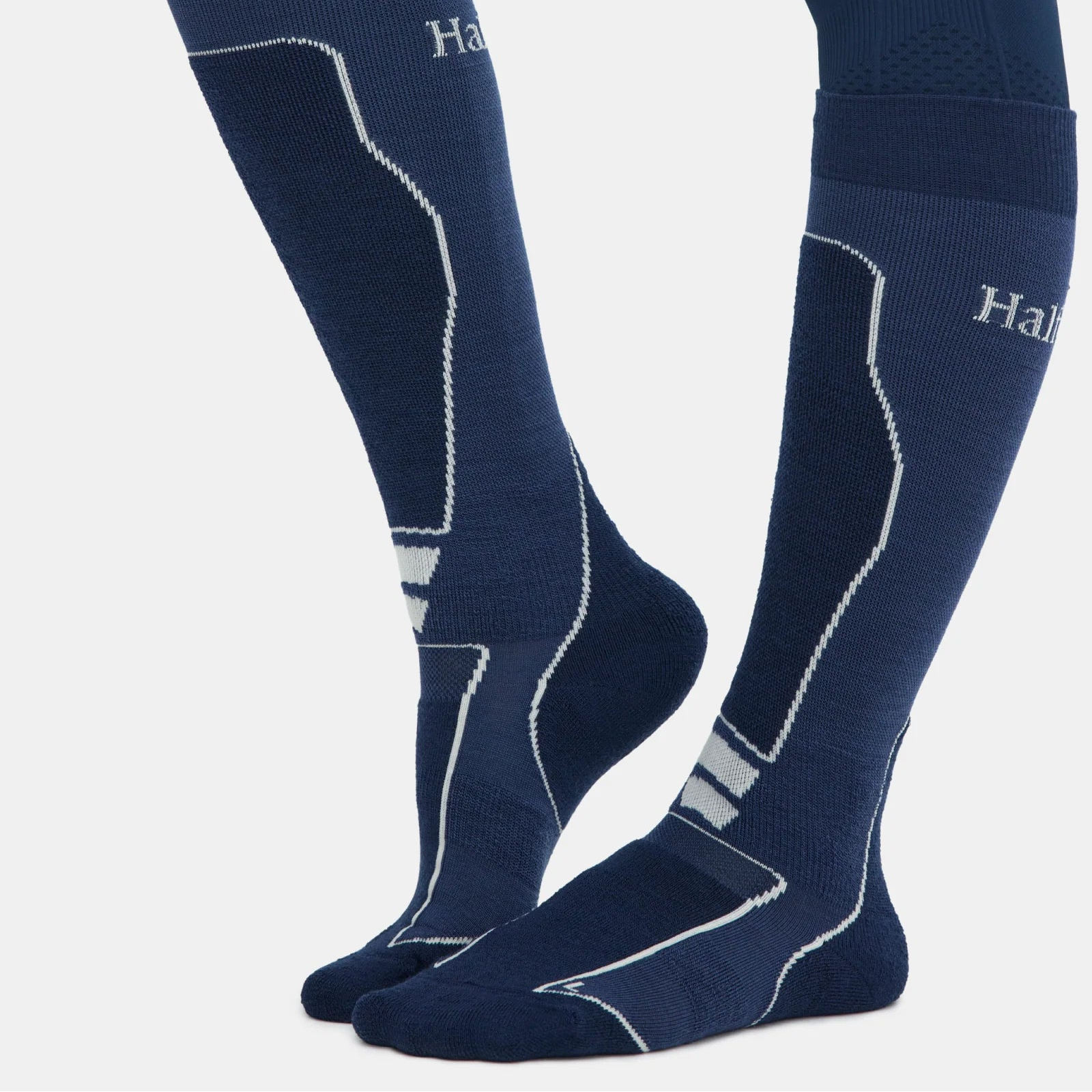 Navy blue riding socks with white stitching on a white background