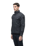A man wearing the Admiral Men's Jacket by Nobis, featuring advanced fabric technology and buttoned pockets, stands against a white background.