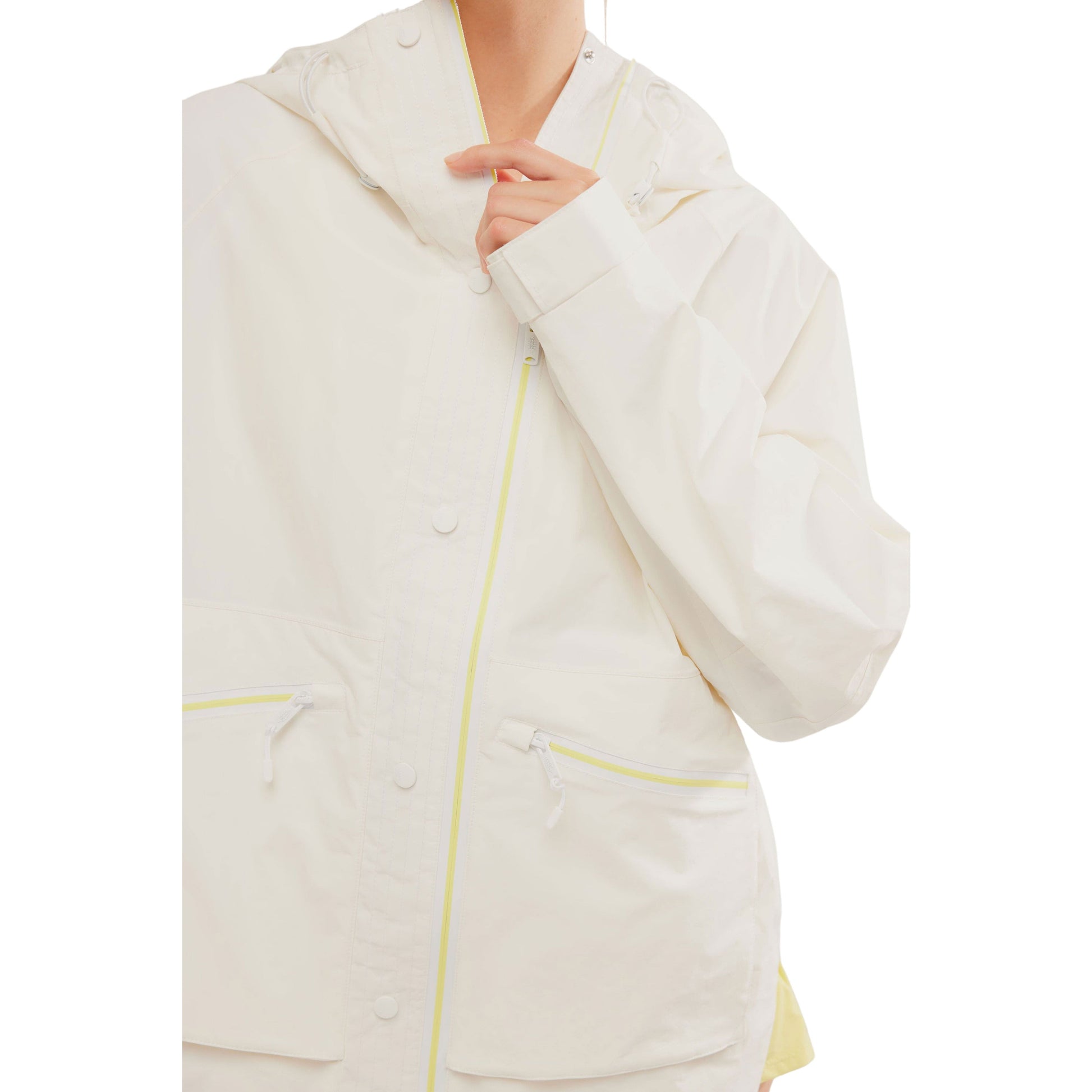 Close-up of a person covered up to the nose, wearing a Free People Movement Singin in the Rain Jacket in Painted White with lime green zipper details.