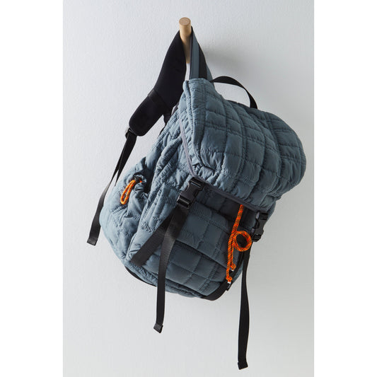Sentence with replaced product: 
Quilted Summit Backpack in Slate with orange zipper pulls hanging on a wooden peg against a white wall. (by Free People Movement)